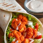Get ready to savor an explosion of flavors with the Ultimate Buffalo Cauliflower Wrap, a fun and hearty option for a quick meal. The combination of crispy buffalo cauliflower and refreshing ranch dressing is sure to please your taste buds and leave you wanting more, whether enjoyed solo or shared at your next gathering.